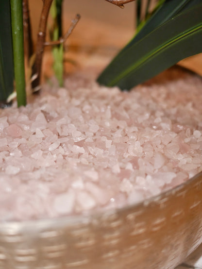 Crème Blush Orchid close up of elegant bowl with genuine rose quartz crystal stone bed and soft foliage