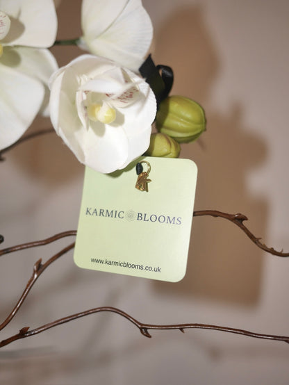 Crème Noir Orchid close up of Karmic Blooms branded label on luxury faux orchid arrangement