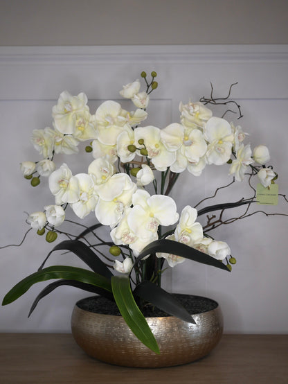 Crème Noir Orchid bespoke faux orchid arrangement with dark crystal bed styled in a luxury interior setting