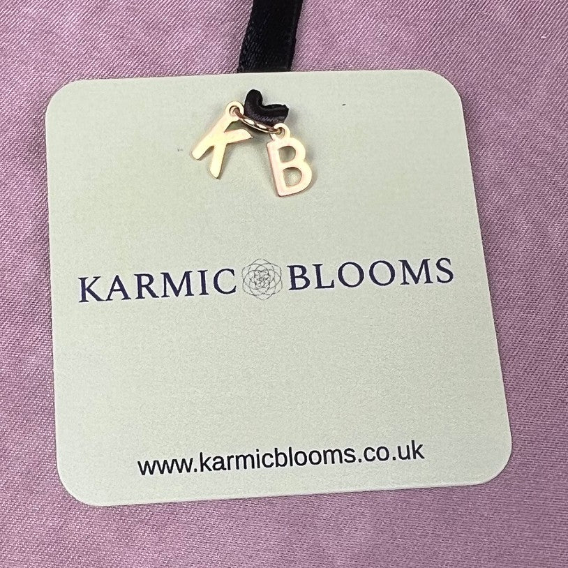 Karmic Blooms branded label with gold lettering — luxury bespoke faux floral arrangements