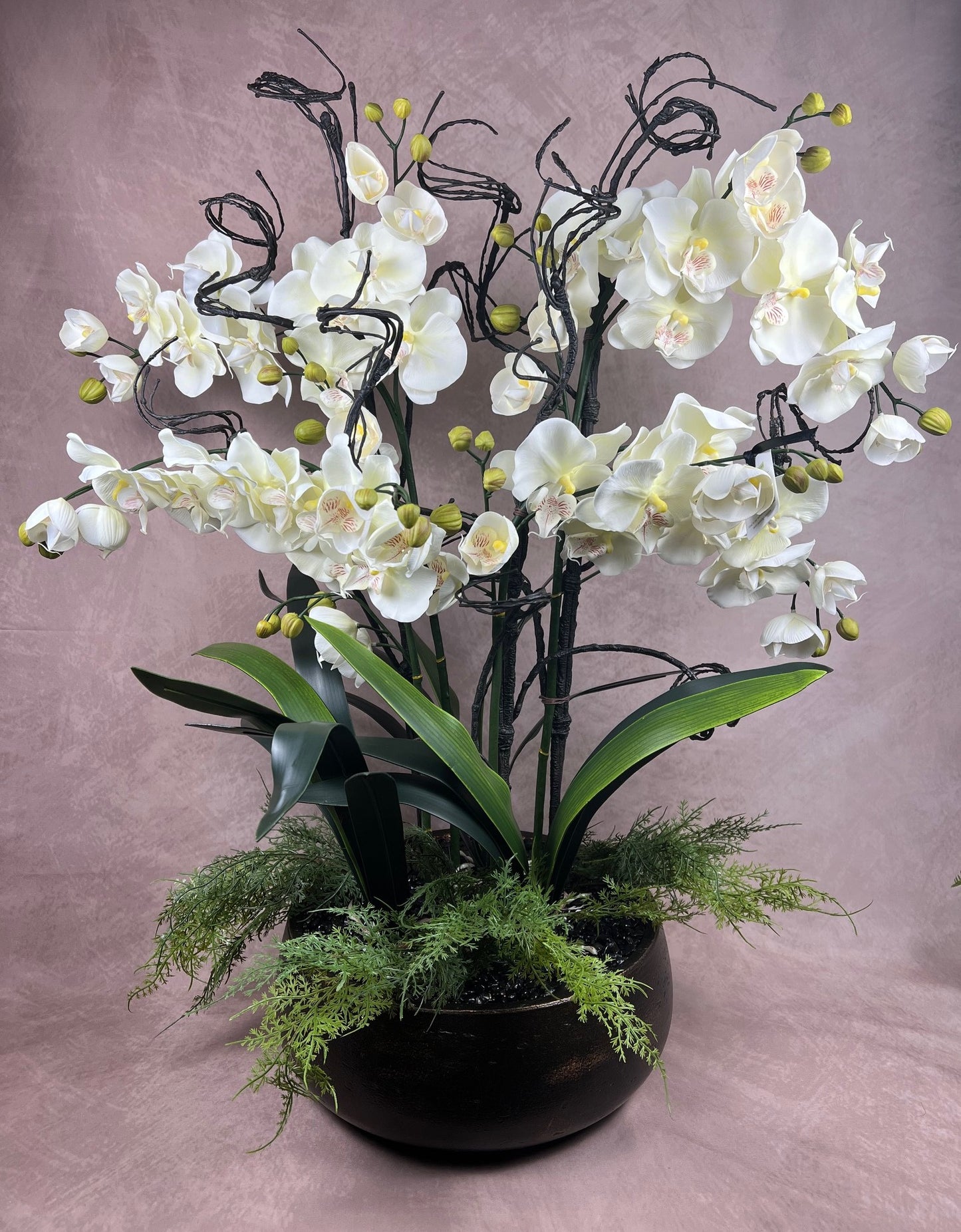 Kensington Noir Orchid bespoke faux orchid arrangement with black tourmaline crystal bed styled in a dramatic luxury interior setting