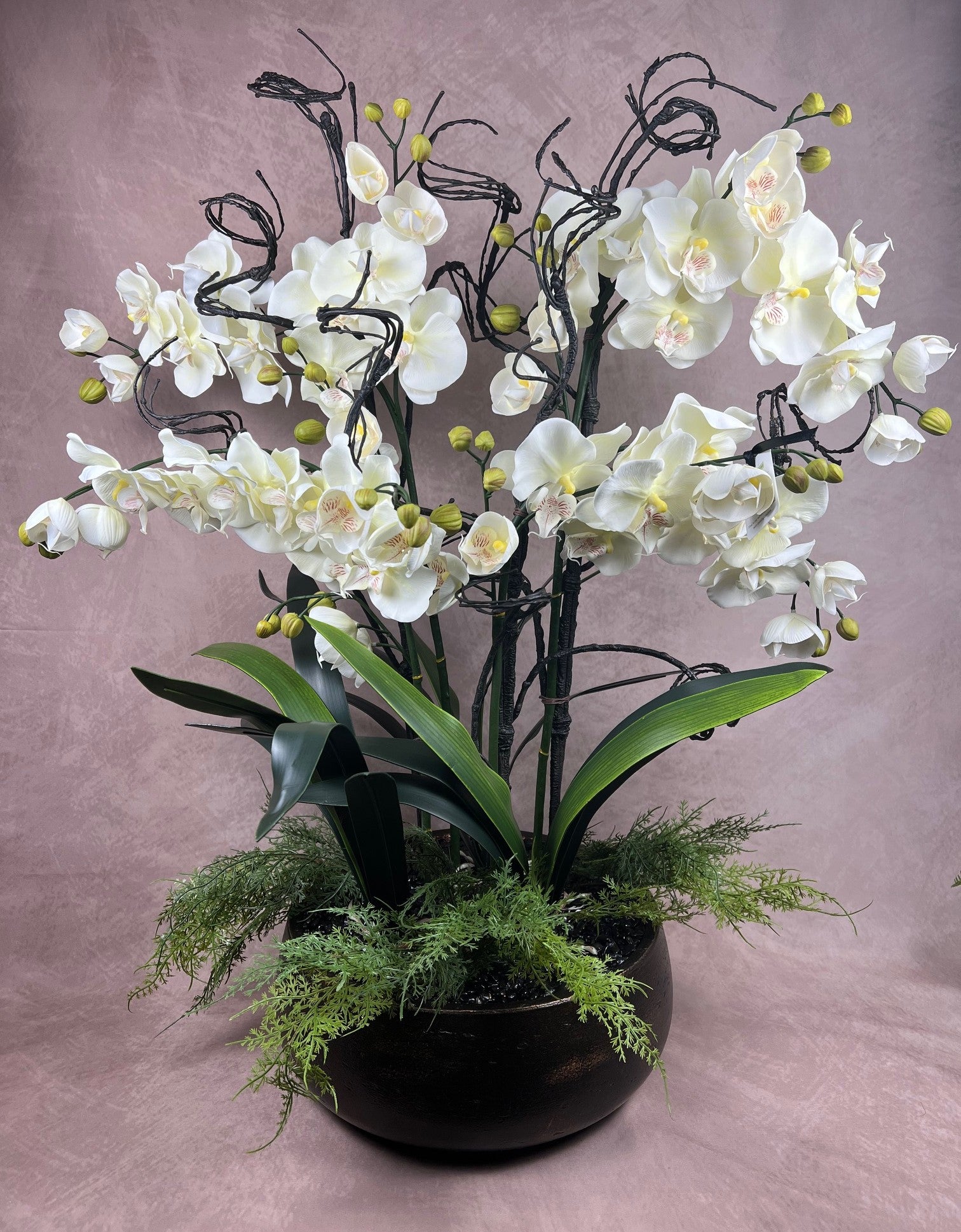 Kensington Noir Orchid bespoke faux orchid arrangement with black tourmaline crystal bed styled in a dramatic luxury interior setting