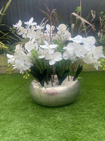 Mayfair Pavilion Orchid large faux orchid display photographed in a sunny outdoor garden setting